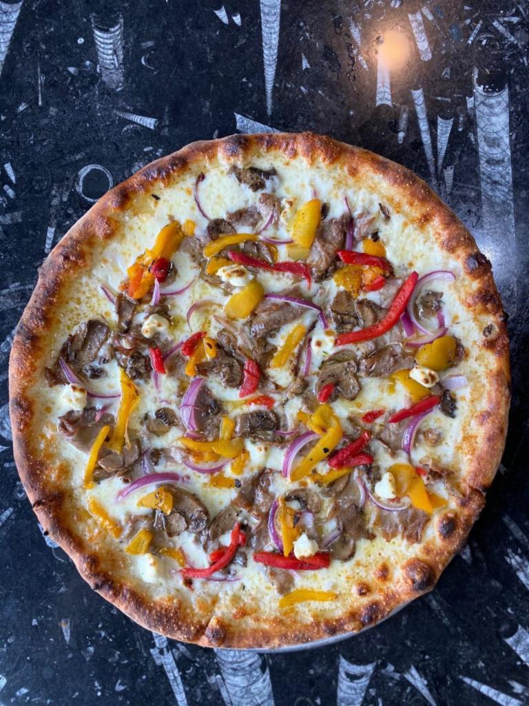 Loaded Philly White Pizza · Braised beef, onions, mushroom, peppers, cream cheese, and creamy horseradish.