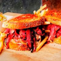 Reuben Sandwich · Served hot. Choice of pastrami, corned beef or turkey on grilled rye with Swiss cheese, Russ...