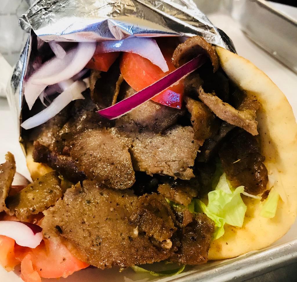Gyro Pita · Seasoned ground lamb and beef slowly sizzled on the rotisserie lettuce, tomato, and onions with tzatziki on the side.