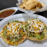 Tostada QB · Tostada with refried beans, choice of meat, topped with lettuce, pico de gallo, sour cream, ...