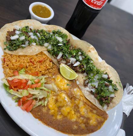 Mexican Street Tacos · Four Mexican street tacos (flour or corn) with choice of meat, topped with onion, cilantro, served with rice and beans 
