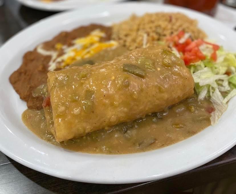 Chimichanga · Chimichanga filled with choice of meat, topped with red or green sauce, served with rice, beans, and sour cream on the side
