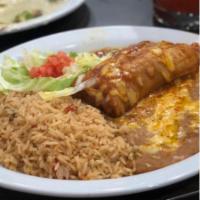 Tamale Enchilada Style · One tamale topped with enchilada sauce and cheese, served with rice and beans  
