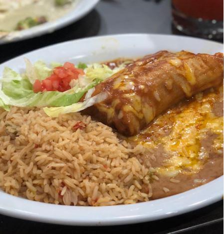 Tamale Enchilada Style · One tamale topped with enchilada sauce and cheese, served with rice and beans  
