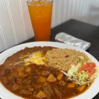 Steak Ranchero · Sliced steak in Mexican red salsa with potatoes, served with rice, beans, and choice of tort...