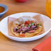 Carnitas Taco · Juicy carlton farms pork cooked with oranges and aromatics.