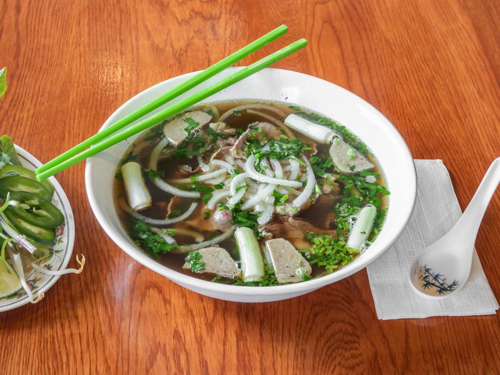 10. Pho with Rare Eye-Round Steak · Pho is prepared with rare eye-round steak and freshly steamed rice noodles. Fresh bean sprouts, basil leaves, cilantro, and onion are provided as an accompaniment for pho. The soup base is made with a home cooking style from beef bone and meat.