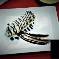 CANNOLI · A golden crisp pastry shell filled with sweet chocolate chip infused ricotta cream.