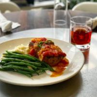 The Meatloaf · garlic whipped potatoes, sautéed green beans, oven roasted tomato relish