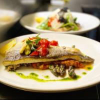 Pan Seared Branzino · bloomsdale spinach, tear drop peppers, olives, baby heirloom tomatoes, lemon