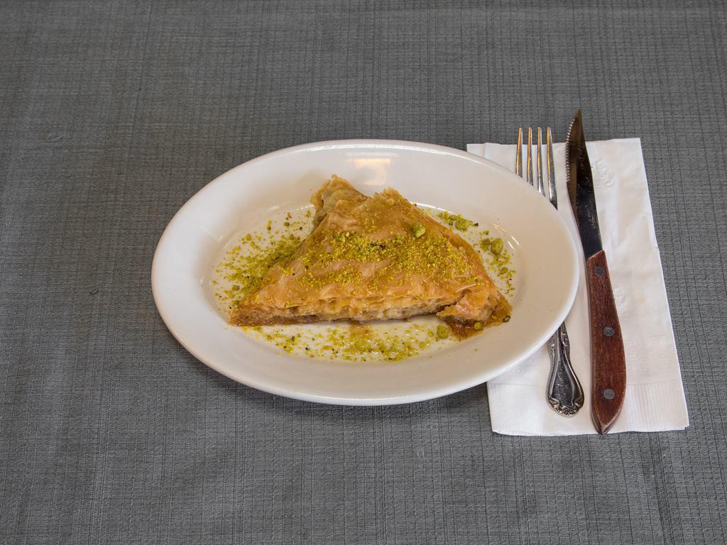 Baklava · Layers of buttery phyllo dough stuffed with chopped nuts and cinnamon. Soaked in a honey.
