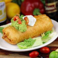 58. Chimichanga · Deep fried burrito, stuffed with beans, rice, cheese, onions and diced tomatoes, served with...