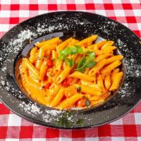 Penne alla Vodka · Penne pasta tossed in a house-made vodka creamy rose sauce, Parmesan cheese and fresh basil.