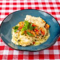 Pollo Limone · Chicken breast with red roasted peppers and capers, white wine garlic lemon sauce.