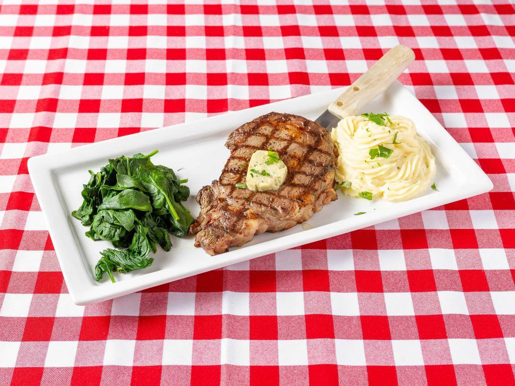 Ribeye al Ferri · Ribeye steak grilled to your taste, topped with Gorgonzola compound butter and served with roasted garlic mashed potatoes and fresh sauteed spinach.
