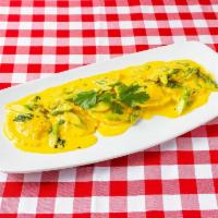 Lobster Ravioli · Ravioli filled with lobster meat, sautéed in a creamy saffron sauce and asparagus tips.