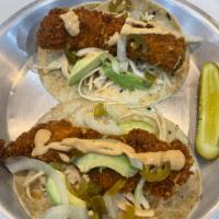 JB Chicken Taco · Two Tacos with Fried Chicken Tender, Cole Slaw, Onion, Avocado, Jalapeño and Chipotle Aioli  