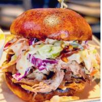 Pulled Pork Sandwich · Slow cooked and hand pulled. Topped with our creamy coleslaw and house BBQ sauce, on a sweet...