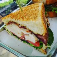 Eastside Turkey Club · Sliced turkey breast topped with smoked bacon, provolone, tomatoes, greens, and pesto aioli,...