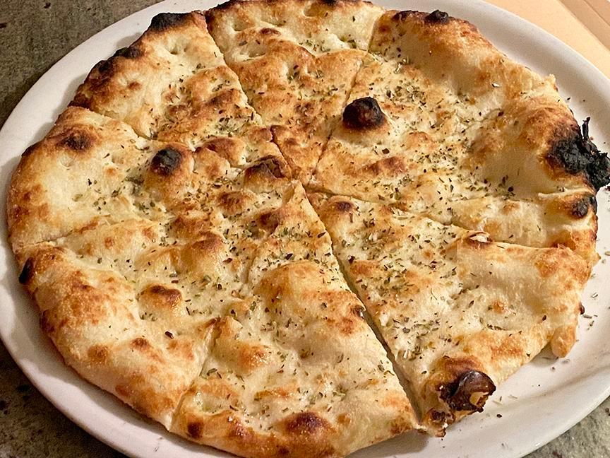 Focaccia Bread (perfectly crisp). · Home Made Pizza-Bread Freshly Baked with our Wood-Fire Oven, Extravergin Olive Oil, Oregano. 