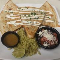 Quesadillas · Toasted flour tortillas with a trio of cheeses, onions and tomatoes. Served with a drizzle o...