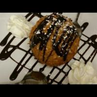 Ice Cream Frito · A generous mound of fried vanilla ice cream drizzled with chocolate and caramel. 
