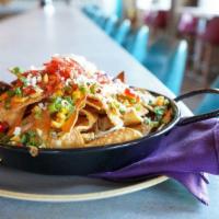 Queso Fundido · Oven fresh nachos loaded w/ Monterey jack, fried beans, pickled red onions, pickled jalapeno...