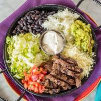 Naked Burrito · The burrito bowl is loaded with rice, beans, pico de gallo, crema, lettuce, Monterrey cheese...