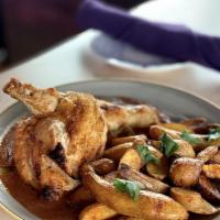 Pollo Al Horno · Pan roasted, crispy skin chicken with adobo sauce + roasted fingerling potatoes,