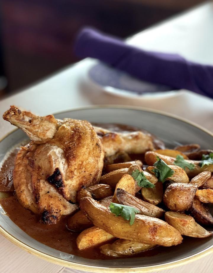 Pollo Al Horno · Pan roasted, crispy skin chicken with adobo sauce + roasted fingerling potatoes,