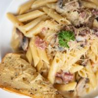 Prociutto Terazzini · Penne sauteed with mushrooms, prosciutto garlic wine & green peas in a creamy sauce topped w...