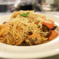  Rose Seafood Fettuccine · Fettuccine tossed with clams, prawns, salmon & garlic in a rose sauce topped with Parmesan c...