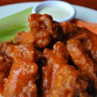 Chicken Wings · Fried chicken wings mixed with choice of sauce, carrots, celery and ranch on the side. Spicy.