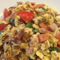 Perico · Scrambled eggs with ham, onion, green pepper and tomatoes. Served with house potatoes, frenc...
