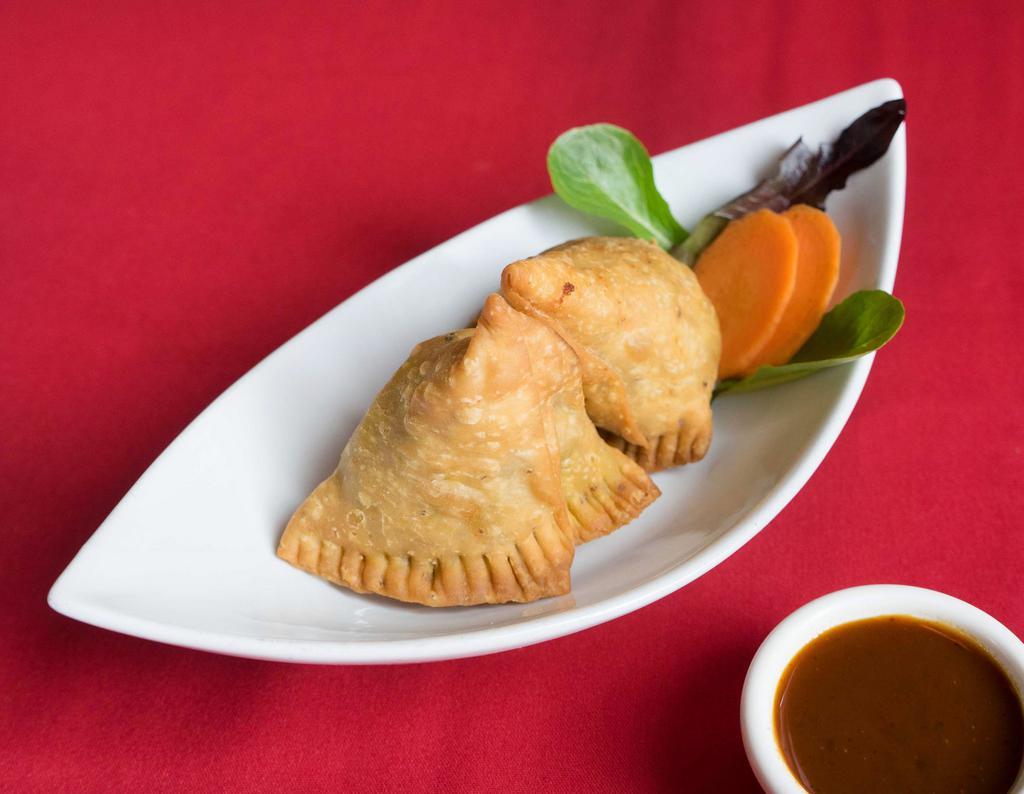 2. Vegetables Samosa · 2 pieces. Deep fried pastry stuffed with spiced potatoes and green peas. Served with tamarind chutney.