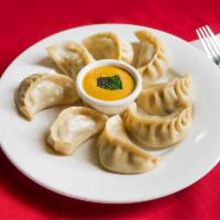 71. Chicken Momo · 8 pieces. Steamed dumplings filled with minced chicken, onion, cilantro and Himalayan herbs ...