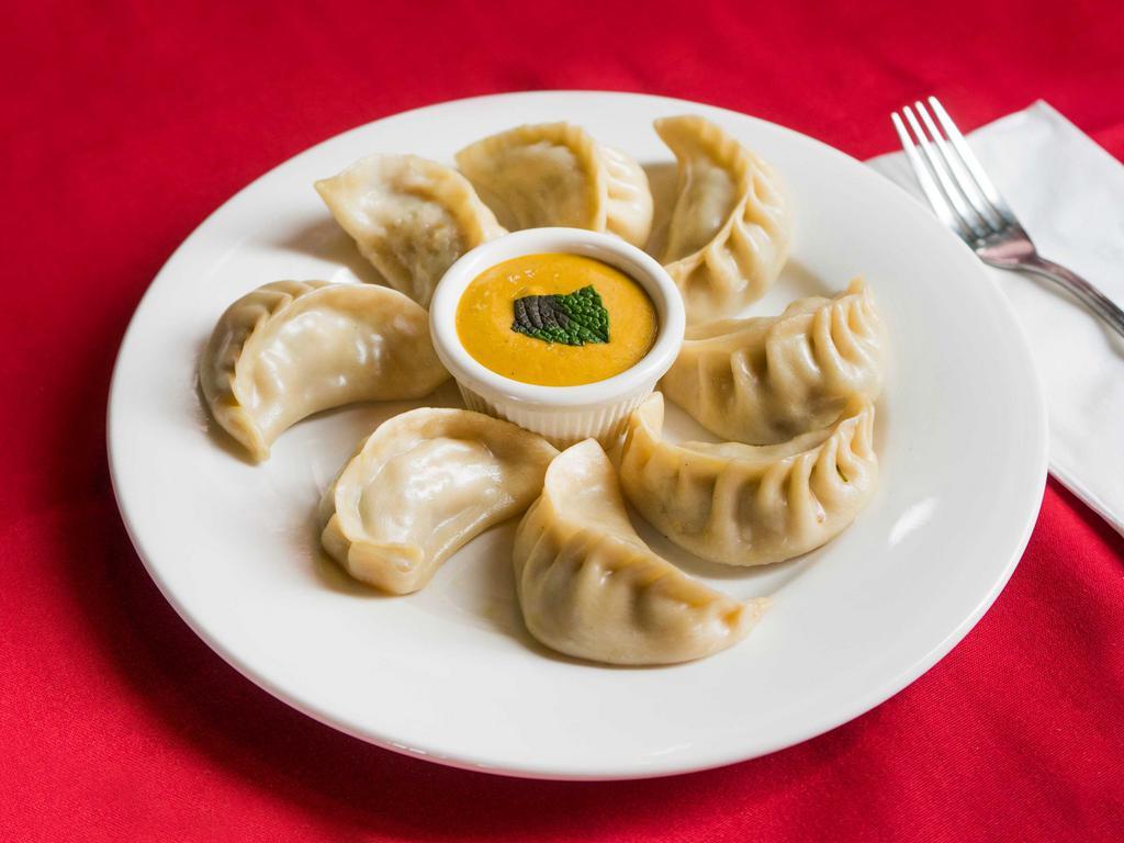 71. Chicken Momo · 8 pieces. Steamed dumplings filled with minced chicken, onion, cilantro and Himalayan herbs and spices. Served with special Himalayan sauce.