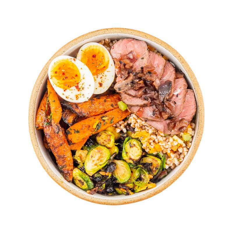 Steak & Eggs. And Brussels · Spiced farro with butternut squash, roasted brussels sprouts, sheet tray carrots, jammy egg with chili oregano salt, and sliced peppercorn steak with grilled onion, with sriracha on the side.  Contains egg, wheat/gluten.