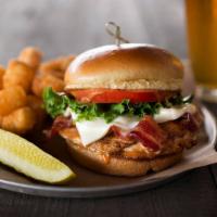 Chipotle Chicken Sandwich · Grilled beer-brined chicken breast smothered in bacon, Swiss cheese and chipotle sauce, serv...