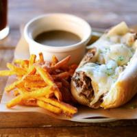 French Dip · Shaved ribeye seasoned and seared, caramelized onions, melted Swiss cheese and garlic aioli ...