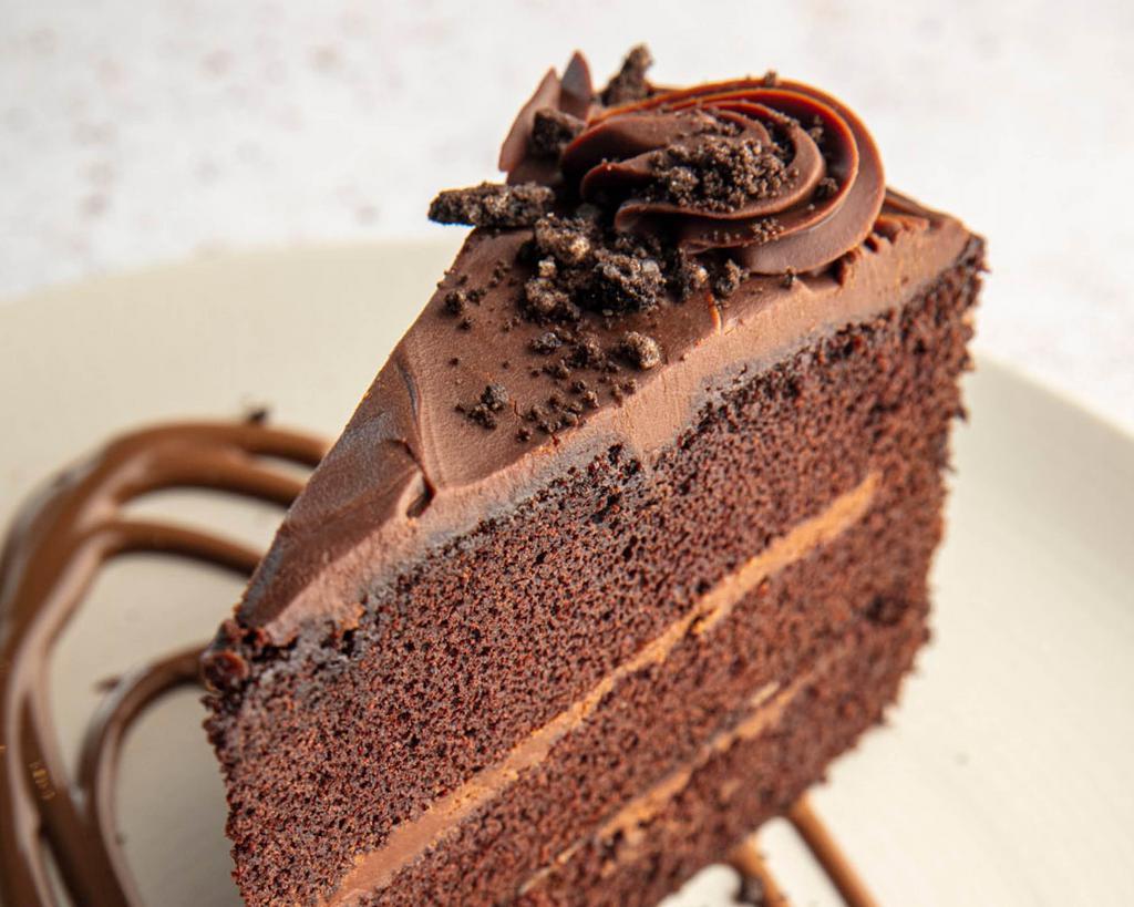 Chocolate Cake · A slice of rich dark chocolate cake served with chocolate crumble topping and chocolate ganache sauce.
