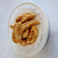 9 Piece Gyoza · Chicken and vegetable mix wrapped in gyoza wrappers then deep-fried.