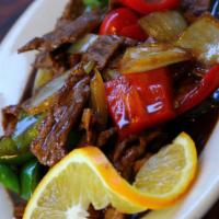 Pepper Steak Stir-Fried · Stir-fried sliced beef with red and green bell peppers and yellow onions in special brown sa...