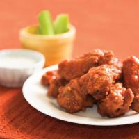 PieZoni’s Wings · On-the-bone wings tossed in our very own dry rub. Served with celery sticks and blue cheese.