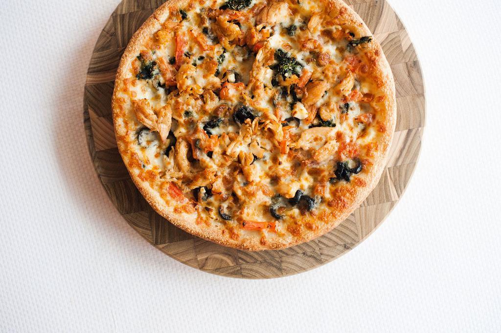 Cyprus Pizza · White pizza (oil and garlic), fresh grilled chicken, olives, tomatoes, spinach and feta cheese.