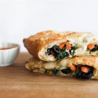 Cyprus Calzone · White pizza(oil and garlic), fresh grilled chicken, olives, tomatoes, spinach and feta cheese.