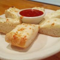 Garlic Cheese Bread · Italian bread topped with garlic butter and smoked mozzarella. Served with a side of marinara.
