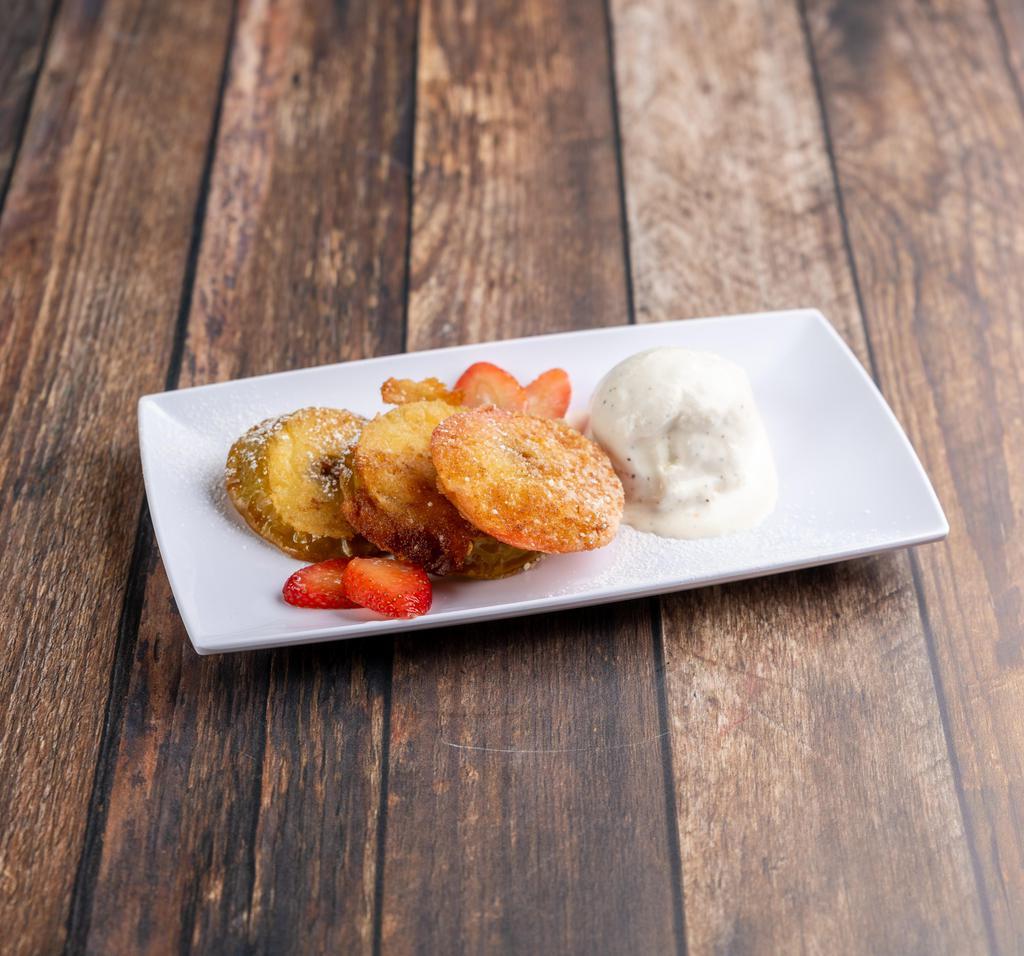 Apple Donuts · Lightly breaded and fried apples, vanilla ice cream, strawberries and caramel. Vegetarian and gluten free.