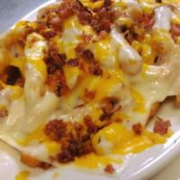 Bacon Cheese Fries · Our famous fries covered in mozzarella, cheddar cheese, delicious bacon. Served with ketchup...