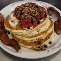 Very Nut & Berry Tower · An Family Pancake House favorite. 4 pancakes topped with strawberry compote, blueberries, fr...